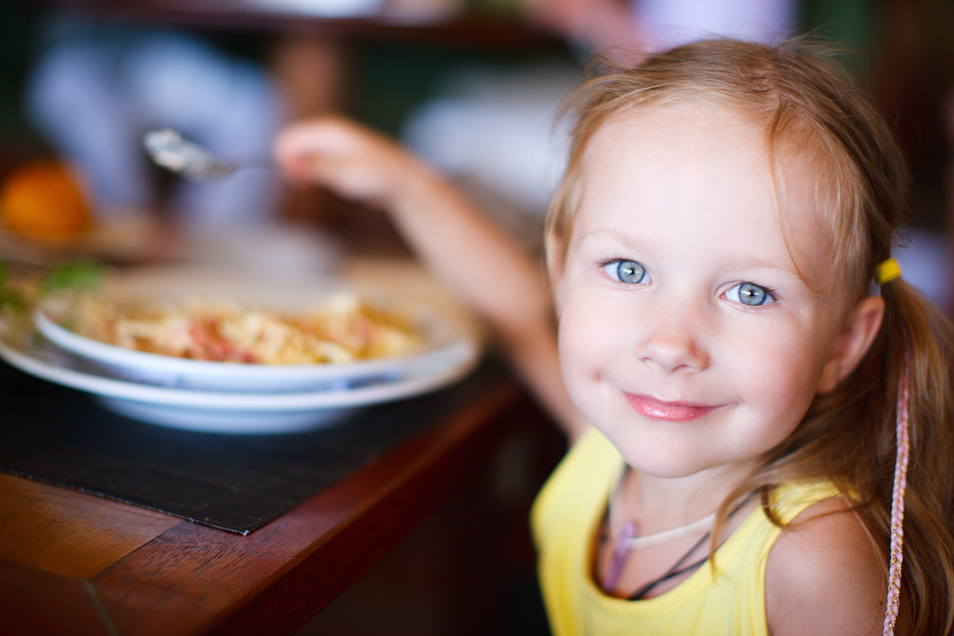 photo of a young girl eating, food provided by a loving parent who the court has determined would be in the best interests of the child to support and take care of her